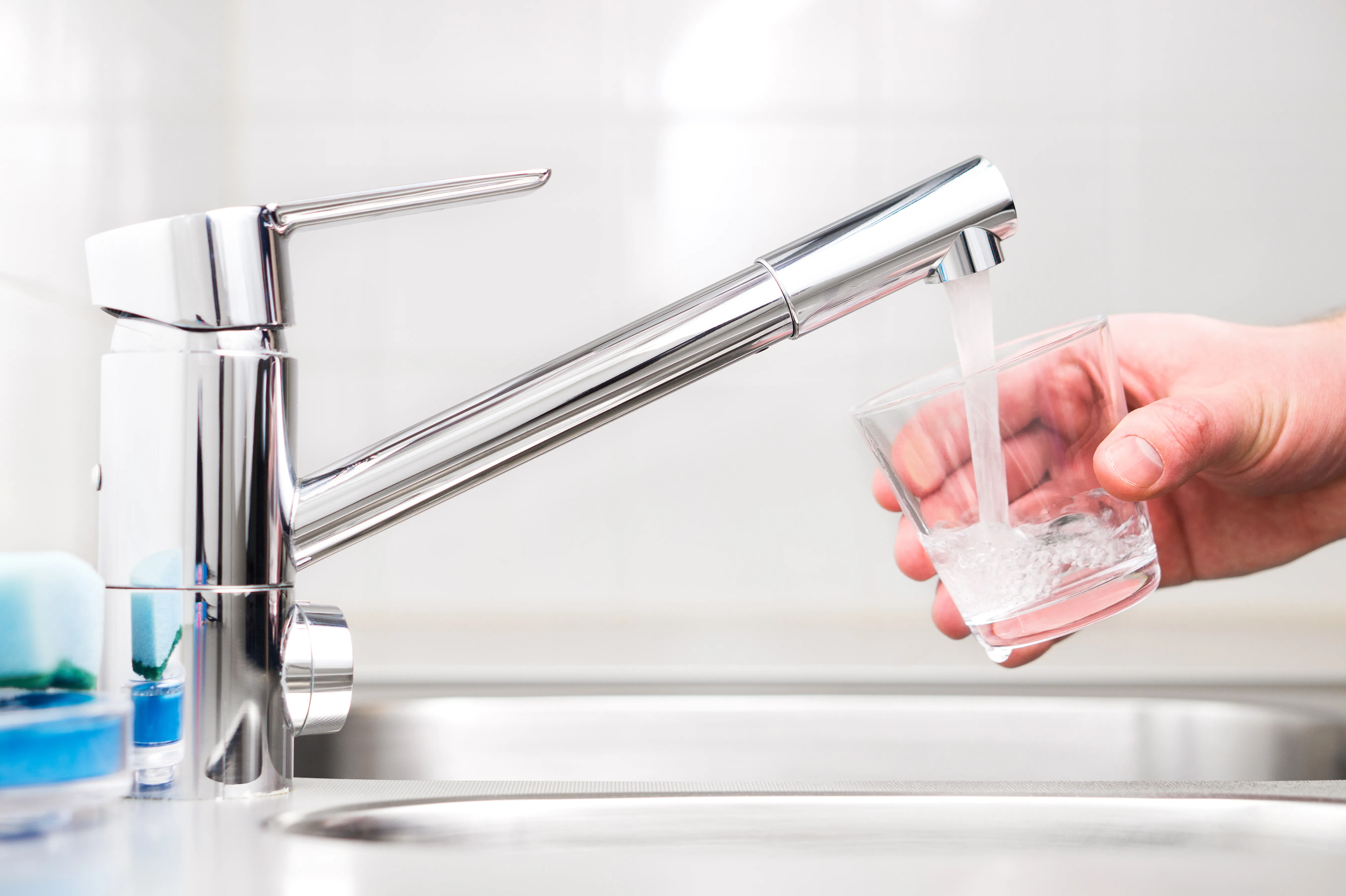 Filling a glass with tap water