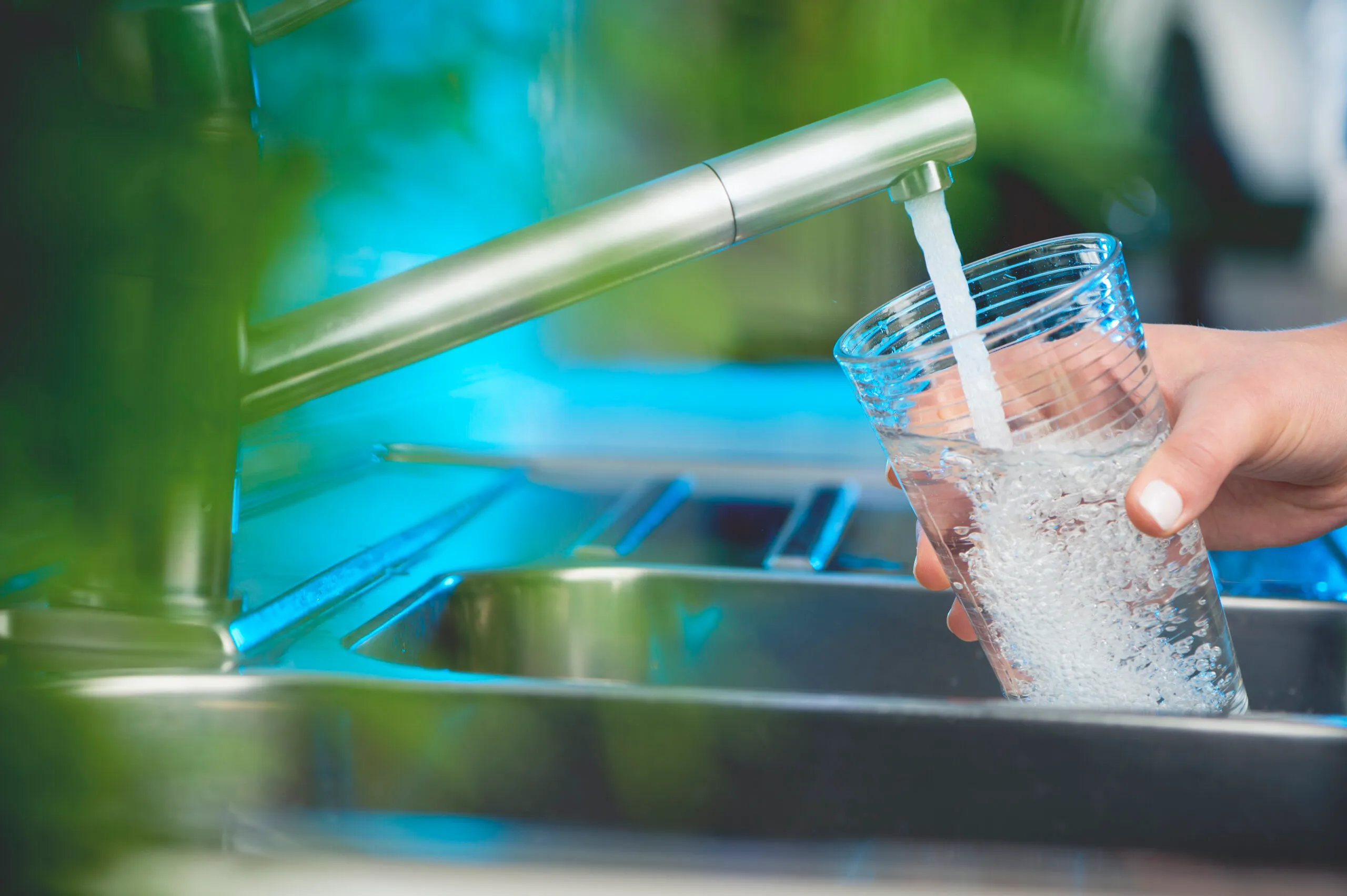 Filling a glass with water from an outdoor tap